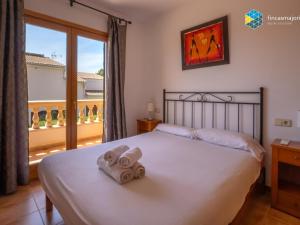a bedroom with a bed with two towels on it at Casa Marco Polo in Cala Mendia +32 photos