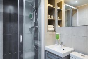 a bathroom with a shower and a sink at FH Confort Hotel Orléans Co'met in Orléans +29 photos