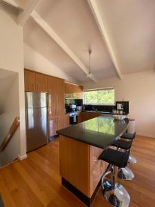 a kitchen with a black counter and a refrigerator at Cowes Holiday Home in Cowes