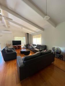 a living room with two couches and a television at Cowes Holiday Home in Cowes