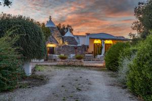 a house with a pathway leading to the front yard at Trulli Li Cridd in Ceglie Messapica