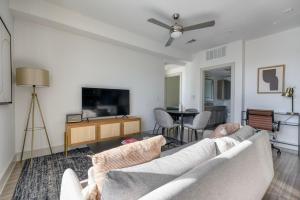 a living room with a couch and a flat screen tv at Downtown 2br w deck gym nr convention center ATX-211 in Austin