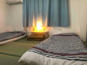 Postel nebo postele na pokoji v ubytování Cozy room in Itabashi