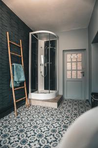 a bathroom with a shower and a wooden ladder at GITE , AU DORMEUR DU VAL in Vireux-Wallerand