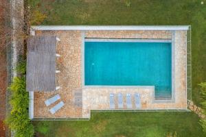 an overhead view of a swimming pool with chairs next to it at Trulli Li Cridd in Ceglie Messapica