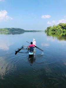 two people in a row boat on a lake at Hikka Secret Lake Resort in Hikkaduwa