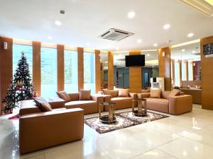 a living room with a christmas tree and couches at HSK Hotel Kuala Lumpur in Kuala Lumpur