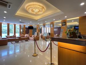 a lobby with a waiting room with couches and a chandelier at HSK Hotel Kuala Lumpur in Kuala Lumpur