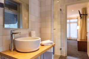 a bathroom with a large bowl sink on a counter at De Zwaan Delden in Delden +23 photos