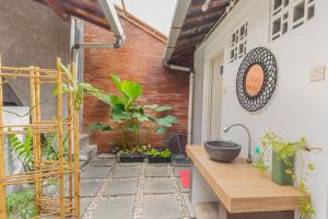 d'une terrasse avec des plantes et une table en bois. dans l'établissement GRIYA BANSU : Ndalem Ibu, à Yogyakarta
