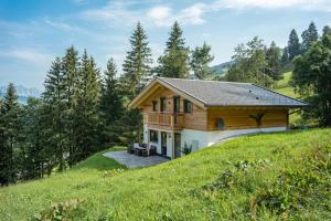 a house on top of a hill at Chalet Alpenherz in Kirchberg in Tirol