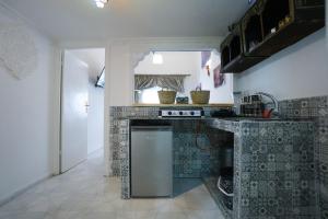 a kitchen with a stove and a counter top at DAR AMR in Tangier