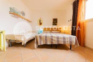 Schlafzimmer mit einem Bett, einem Tisch und einem Fenster in der Unterkunft Casa Mimy (Piano Terra) - 700 mt dal mare in Porto Cesareo