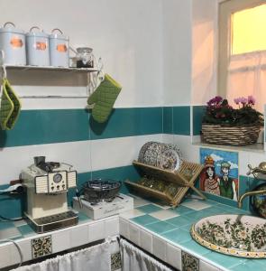 a kitchen with a counter with plates on it at Maison al Duomo in Messina