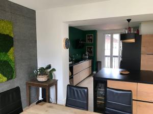 a kitchen with a table and chairs in a room at Maison Sallanches 12 couchages in Sallanches +10 photos
