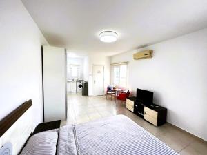 a bedroom with a bed and a tv in it at Студия в жилом комплексе Caesar Beach D1 Flat10 in Boğaz +33 photos