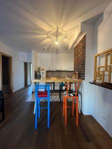 a kitchen with a table with colorful chairs at Sava apartment in Novi Sad