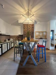 a kitchen with a table and chairs in a room at Sava apartment in Novi Sad