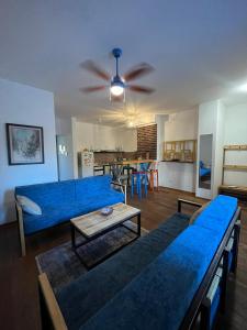a living room with a blue couch and a table at Sava apartment in Novi Sad