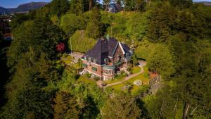 an aerial view of a large house on a hill at Unique Victorian Villa with private coastline in Bergen