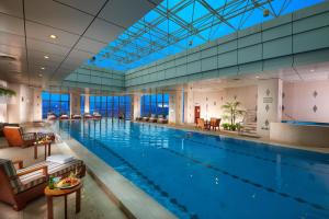 a large swimming pool in a hotel room at Songjiang New Century Grand Hotel Shanghai in Songjiang