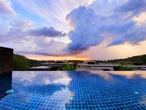 a swimming pool with a sunset in the background at Designer Panoramic Seaview 2br Pool Villa Naithon Beach num7131 in Nai Thon Beach
