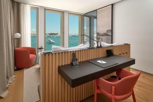 an office with a desk and chairs with a view of the ocean at Hotel Ambasador in Split