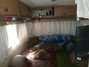 a room with a couch and a tv in a trailer at Caravan have TV & Netflix in Bangkok