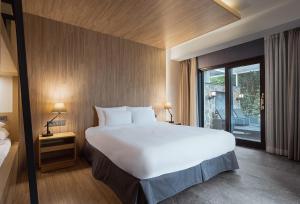 Postel nebo postele na pokoji v ubytování The Suites Hotel Jeju