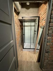 a door to a room with a window and a brick wall at Stay in Poznan Tropical in Poznań