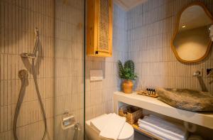 a bathroom with a shower and a toilet and a sink at Noi Hotel Bodrum in Bodrum City