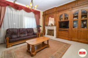 a living room with a leather couch and a table at Villa Cerca Del Mar num1125 in Blanes