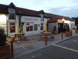 a group of picnic tables in front of a building at The Half Moon Inn in Ashington