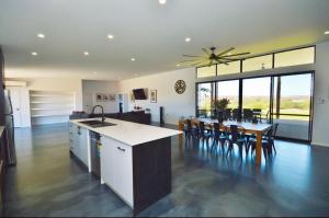a kitchen and dining room with a table and chairs at Off The Hook Kalbarri in Kalbarri