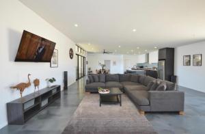 a living room with a couch and a table at Off The Hook Kalbarri in Kalbarri