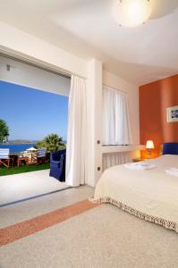 a bedroom with a bed and a view of the ocean at Elounda Living Residences in Elounda