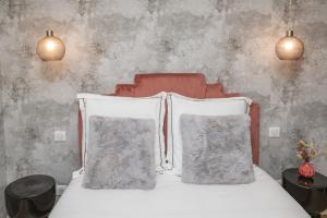 a bedroom with a bed with two pillows on it at The New Bliss - Duke Housing in Vitry-sur-Seine