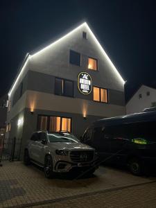 a car parked in front of a building at night at Avento Hotel Hannover in Hannover