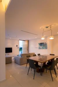 a living room with a table and a couch at Seaview Luxury Villa Jacuzzi & Pool! 2 Min Beach in Protaras