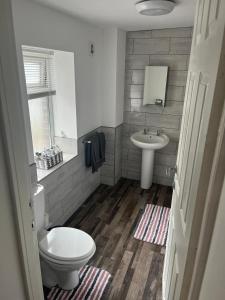 a bathroom with a toilet and a sink at The Old Post Office Apartment in Adlington