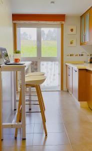 a kitchen with a table and a laptop on it at Apartamento Buen Camino in O Pedrouzo