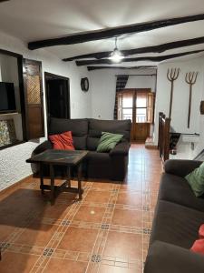 a living room with a couch and a table at Casa Pepo in Pampaneira