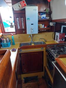 a kitchen with a sink and a stove at Marina Oasis, Your Boatel in Puerto Calero