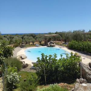 a large swimming pool in a yard with trees at Cuccuru Relax - A IUN Q9882 in Orosei