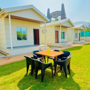 a table and chairs in front of a house at Tara's Hill Resort in Lonavala