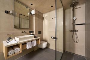 a bathroom with a sink and a shower at Hotel Ambasador in Split