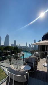 a balcony with chairs and tables and a view of a city at The address opera t1 burj khalifa in Dubai