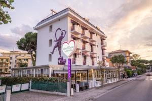 a building with a heart sign in front of it at Hotel Germania in Lido di Jesolo