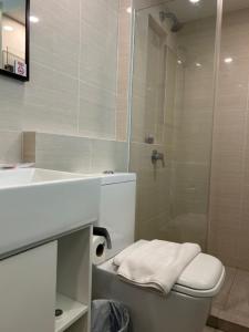 a bathroom with a shower and a toilet and a sink at Link Hotel Singapore in Singapore