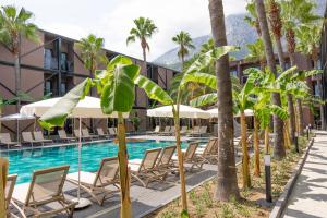 a pool at the resort with chairs and umbrellas at Golden Sun Hotel Adult Only in Beldibi +72 photos